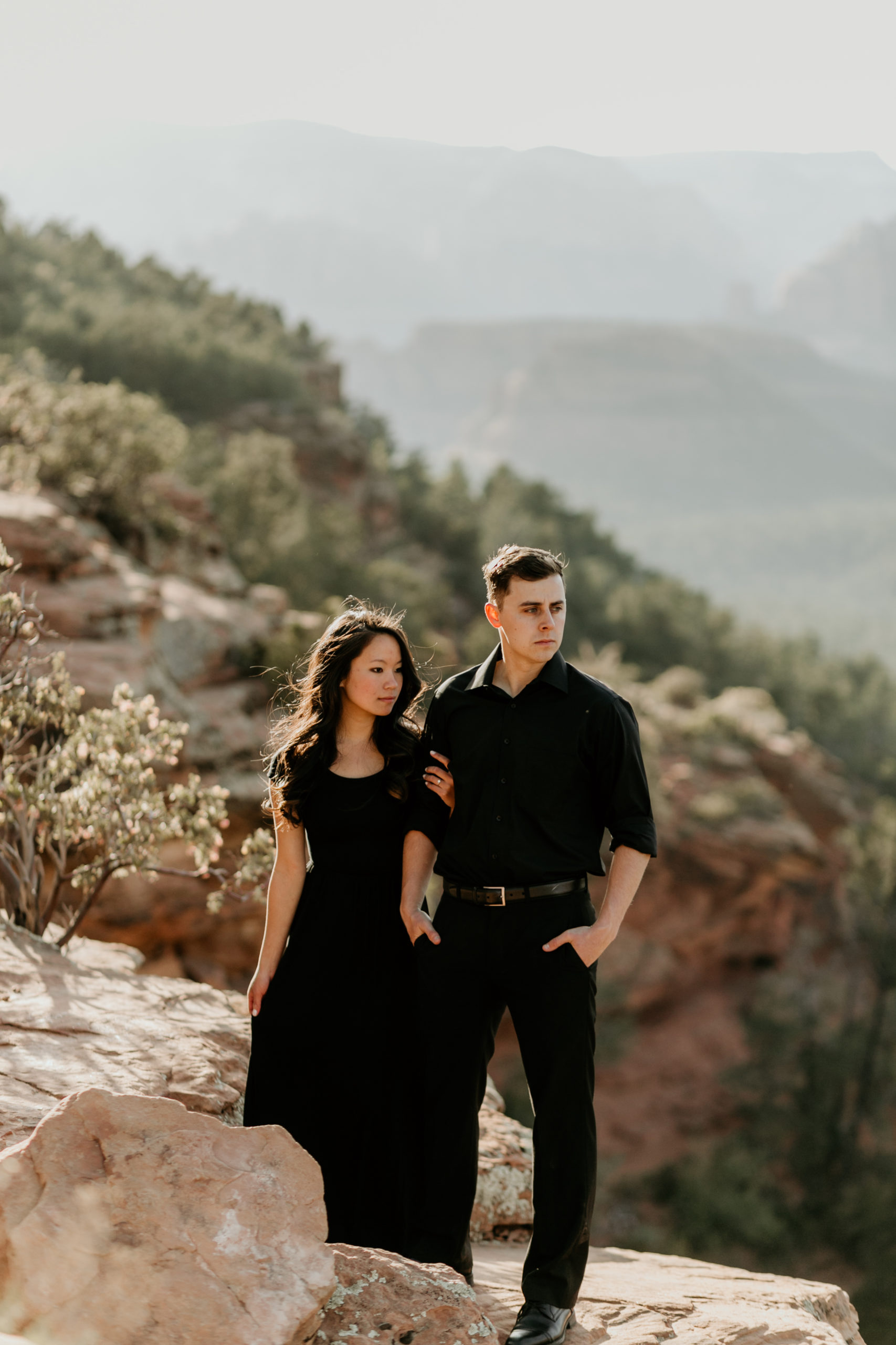 Couple stands near edge of cliff on Devil's Bridge in Sedona Arizona
